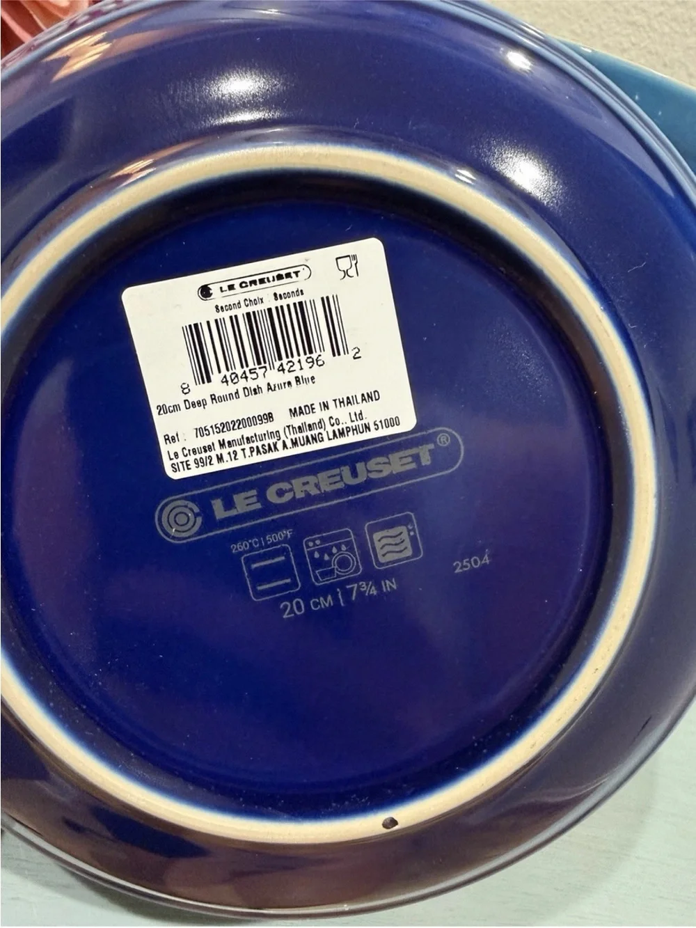 The product is a set of 4 Le Creuset deep round dish plates in a striking azure